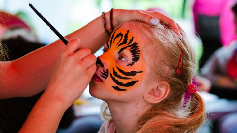 Photo of a child getting their face painted